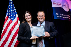 enator Jon Tester (MT) presenting the Community Development award to Courtney McKee of Headframe Spirits in Butte, MT.